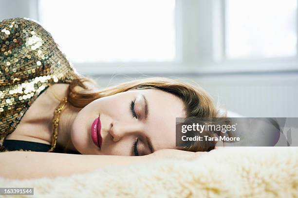 woman dressed up asleep on bed - beautiful woman sleeping stock pictures, royalty-free photos & images