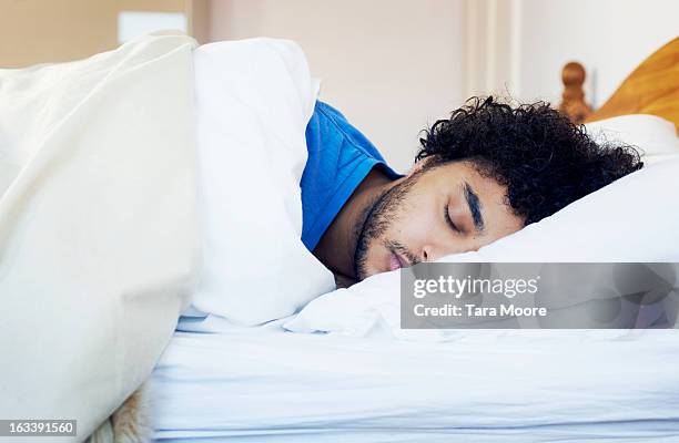 man asleep in bed - dream imagens e fotografias de stock