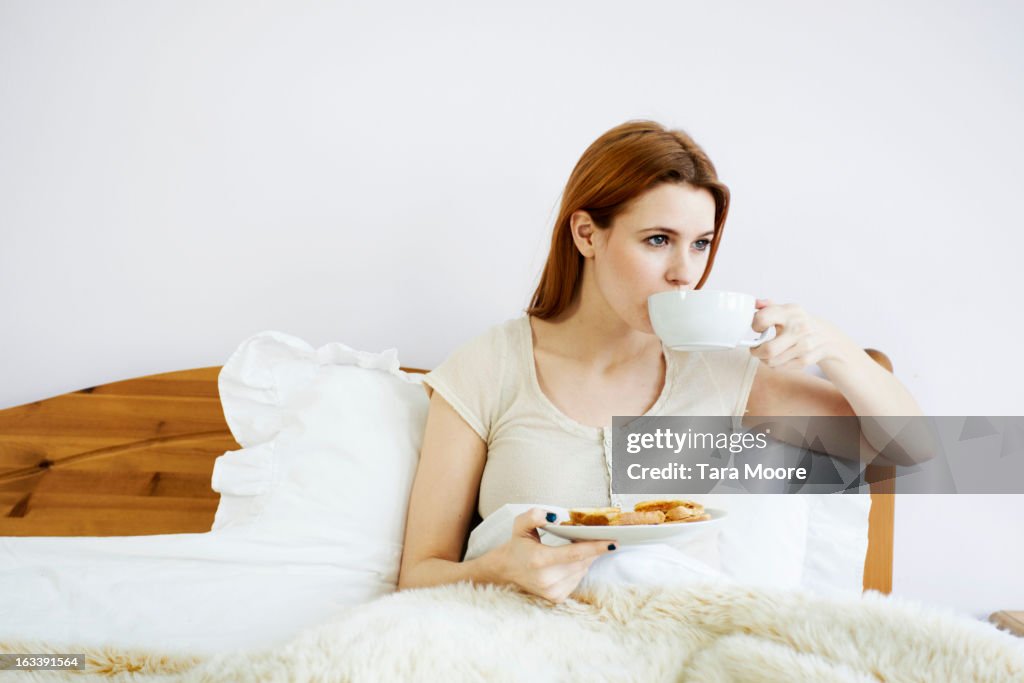 Woman having breakfast in bed