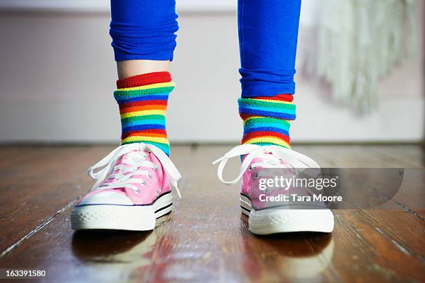 close of of child's feet wearing colourful socks - girl shoes stock-fotos und bilder