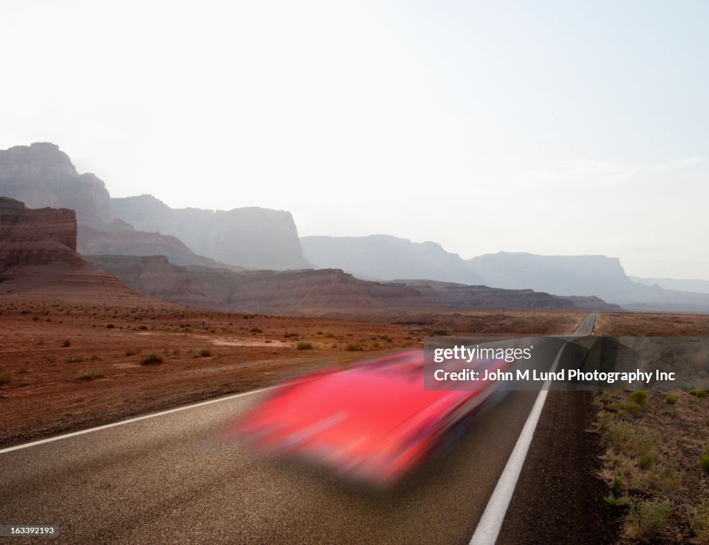 Blurred view of convertible on remote highway