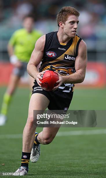 Reece Conca of the Richmond Tigers runs with the ball during the round three NAB Cup AFL match between the Hawthorn Hawks and the Richmond Tigers at...