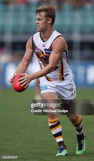 Sam Mitchell of the Hawthorn Hawks looks ahead with the ball during the round three NAB Cup AFL match between the Hawthorn Hawks and the Richmond...