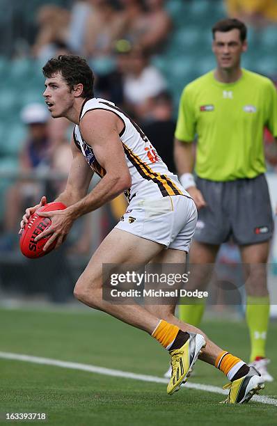 Isaac Smith of the Hawthorn Hawks looks ahead with the ball during the round three NAB Cup AFL match between the Hawthorn Hawks and the Richmond...