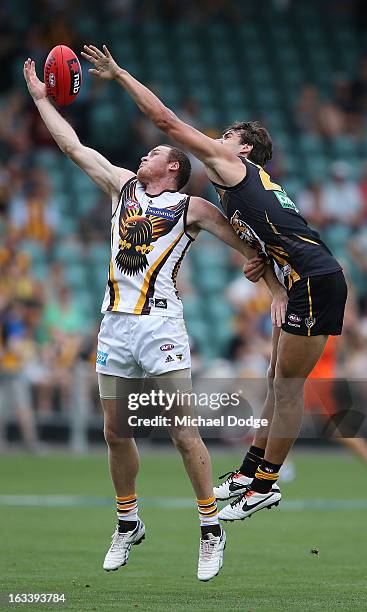Jarryd Roughead of the Hawthorn Hawks marks the ball against Ben Griffiths of the Richmond Tigers during the round three NAB Cup AFL match between...