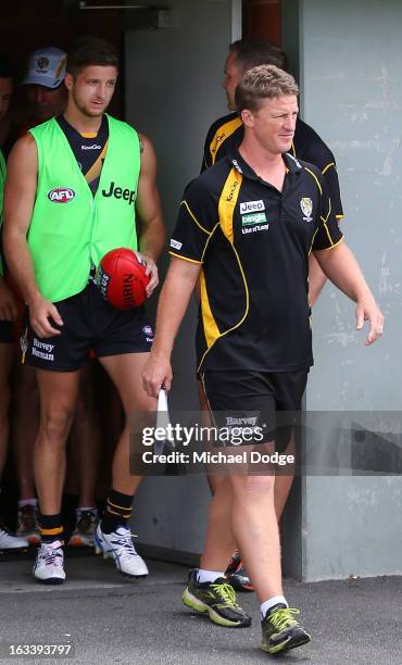 Richmond Tigers coach Damien Hardwick leads the team out after their three quarter time break was taken in the rooms due to the heat during the round...