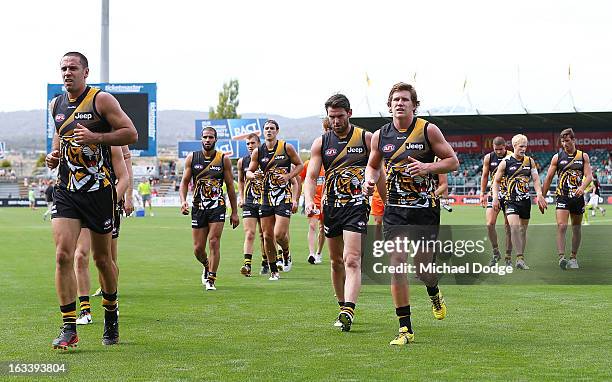 Richmond Tiger players walk to the rooms for their quarter time huddle due to the heat during the round three NAB Cup AFL match between the Hawthorn...