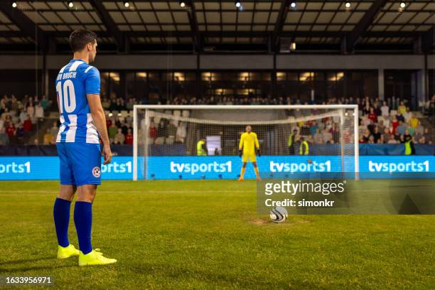 football player standing on football pitch - penalty kick stock pictures, royalty-free photos & images