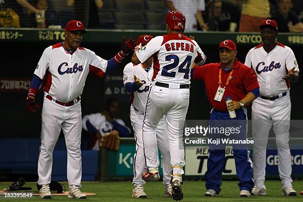 Outfielder Frederich Cepeda of Cuba celebrates after hits a two run home run in the top half of the first inning during the World Baseball Classic...