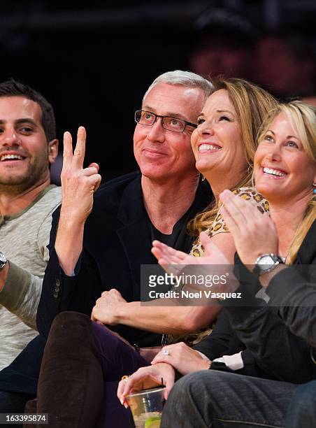 Drew Pinsky and his wife Susan Pinsky kiss at a basketball game between the Toronto Raptors and Los Angeles Lakers at Staples Center on March 8, 2013...
