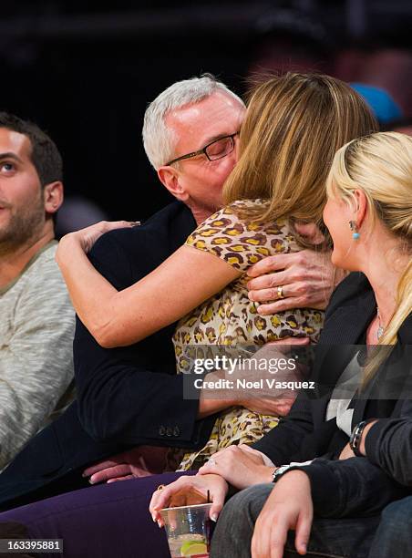 Drew Pinsky and his wife Susan Pinsky kiss at a basketball game between the Toronto Raptors and Los Angeles Lakers at Staples Center on March 8, 2013...