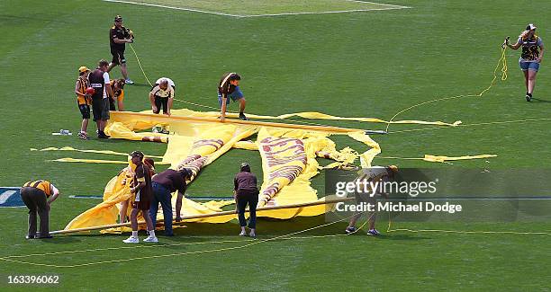 The Hawthorn Hawks cheer squad had their banner ripped by hig winds before the round three NAB Cup AFL match between the Hawthorn Hawks and the...