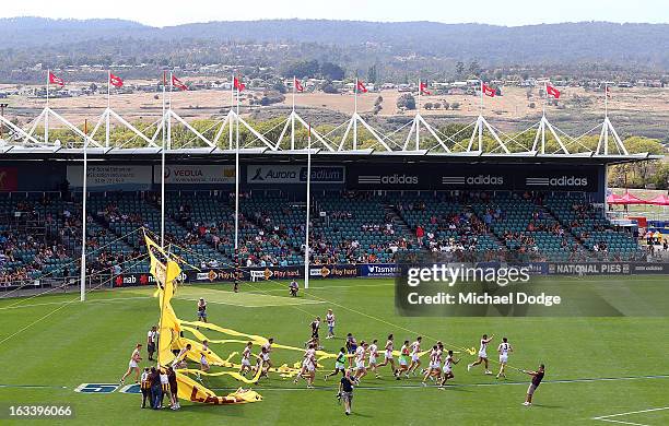 General view as the Hawthorn Hawks run through their banner before the round three NAB Cup AFL match between the Hawthorn Hawks and the Richmond...