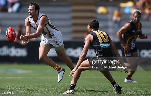 Jordan Lewis of the Hawthorn Hawks handpasses the ball during the round three NAB Cup AFL match between the Hawthorn Hawks and the Richmond Tigers at...