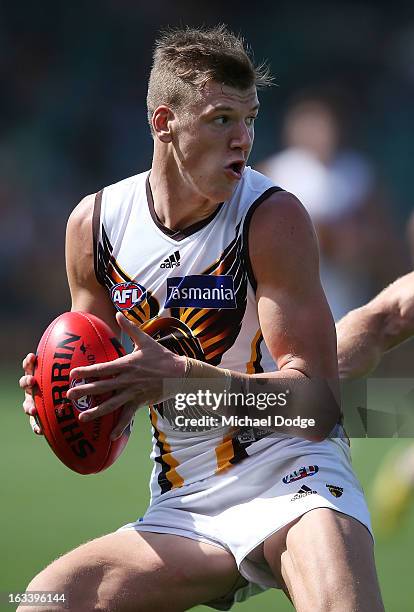 Sam Grimley of the Hawthorn Hawks looks ahead with the ball during the round three NAB Cup AFL match between the Hawthorn Hawks and the Richmond...