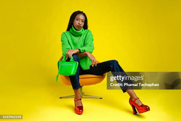 beautiful woman wearing sweater and jeans - black purse stock pictures, royalty-free photos & images