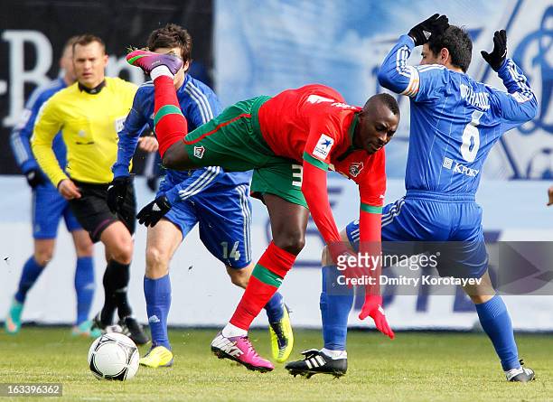 Dame N'Doye of FC Lokomotiv Moscow falls in a challenge with Leandro Fernandez of FC Dynamo Moscow during the Russian Premier League match between FC...