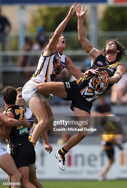 Ty Vickery of the Richmond Tigers jumps into Sam Grimley of the Hawthorn Hawks during the round three NAB Cup AFL match between the Hawthorn Hawks...