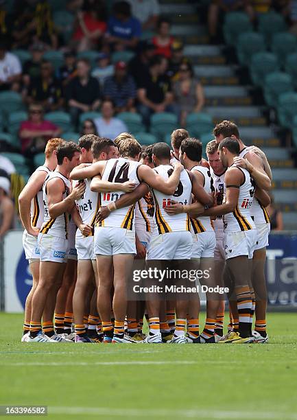 Hawthorn Hawks players form a huddle before the round three NAB Cup AFL match between the Hawthorn Hawks and the Richmond Tigers at Aurora Stadium on...