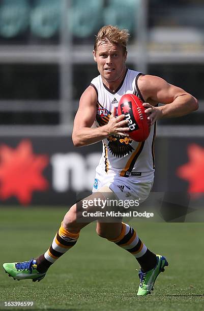 Sam Mitchell of the Hawthorn Hawks runs with the ball during the round three NAB Cup AFL match between the Hawthorn Hawks and the Richmond Tigers at...