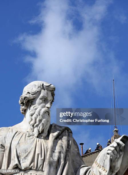 Members of the Vatican Fire Brigade install the chimney on the top of the Sistine Chapel which will emit smoke as cardinals prepare to vote for a new...