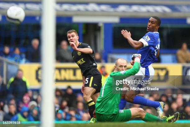 Callum McManaman of Wigan Athletic scores his sides third goal as Sylvain Distin and goalkeeper Jan Mucha of Everton look on during the FA Cup Sixth...