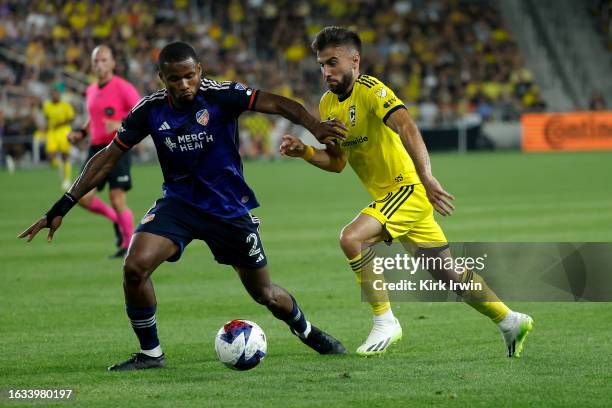 Diego Rossi of the Columbus Crew and Alvas Powell of FC Cincinnati battle for control of the ball during the match at Lower.com Field on August 20,...