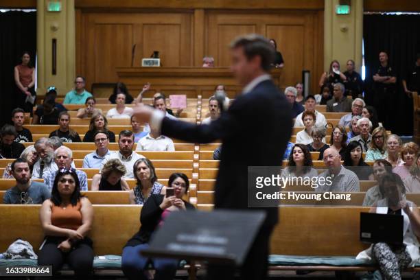 Denver mayor Mike Johnston, front, discuss about homelessness with citizens during his first town hall meeting at the Central Presbyterian Church in...