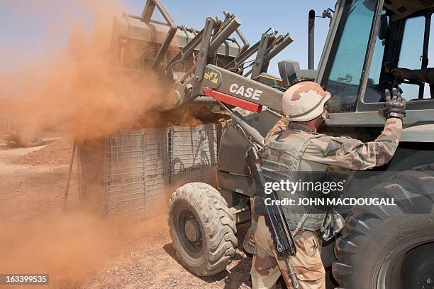 French soldiers of an engineering unit build a defensive position to protect the airport in Gao on March 9 where the French forces haves established...