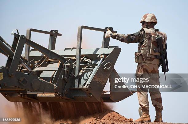 French soldiers of an engineering unit build a defensive position to protect the airport in Gao on March 9 where the French forces haves established...