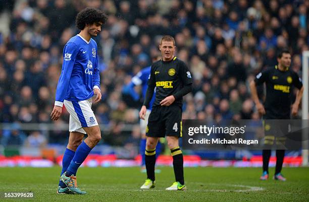 Marouane Fellaini of Everton looks dejected as he is substituted by Everton manager David Moyes during the FA Cup Sixth Round match between Everton...