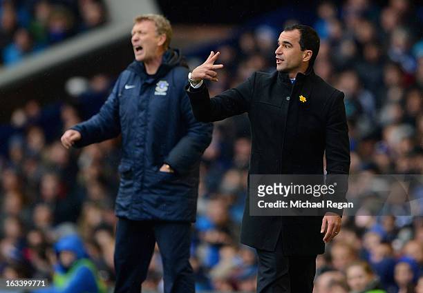 Wigan manager Roberto Martinez gestures as Everton manager David Moyes looks on during the FA Cup Sixth Round match between Everton and Wigan...