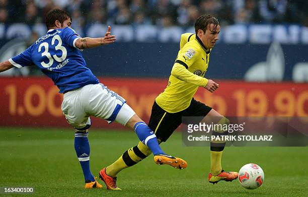 Schalke's midfielder Roman Neustaedter and Dortmund's midfielder Mario Goetze vie for the ball during the German first division Bundesliga football...