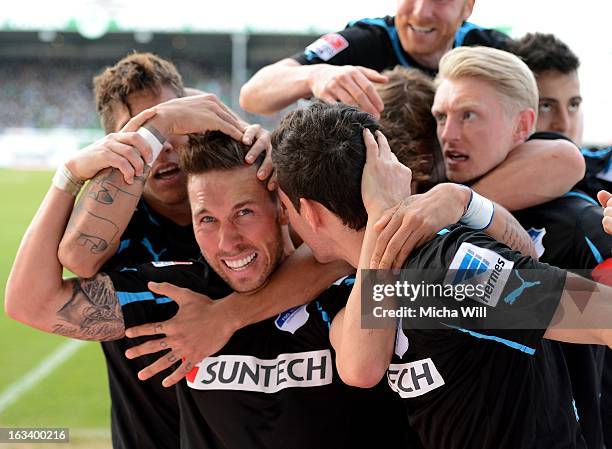 Tobias Weis of Hoffenheim celebrates the third goal for his team with teammates during the Bundesliga match between SpVgg Greuther Fuerth and TSG...