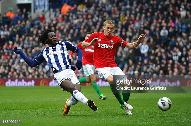Romelu Lukaku of West Bromwich Albion scores the equalising goal under pressure from Garry Monk of Swansea during the Barclays Premier League match...