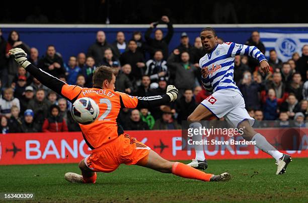 Loic Remy of Queens Park Rangers scores their first goal past Simon Mignolet of Sunderland during the Barclays Premier League match between Queens...