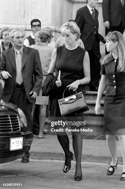 Mourners including Diana Spencer attend a memorial service for fashion designer Gianni Versace at the Duomo in Milan, Italy, on July 22, 1997.