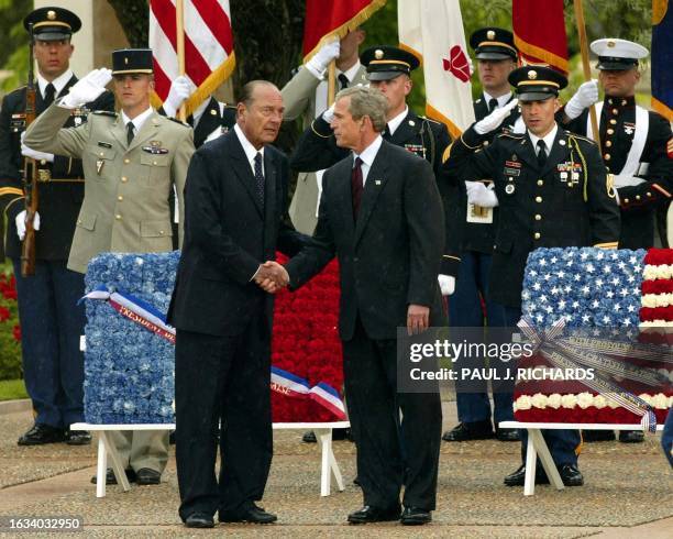 French President Jacques Chirac and US President George W. Bush say their farewells before leaving the World War II Normandy American Cemetery after...