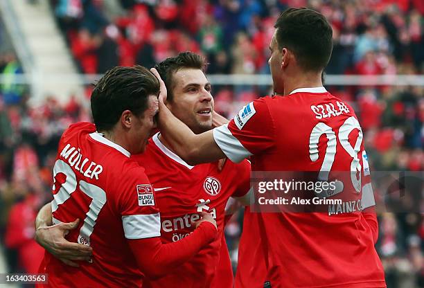Andreas Ivanschitz of Mainz celebrates his team's first goal with team mates Nicolai Mueller and Adam Szalai during the Bundesliga match between 1....
