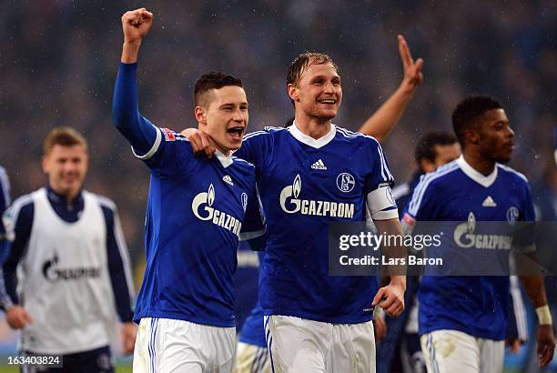 Julian Draxler and Benedikt Hoewedes celebrate after winning the Bundesliga match between FC Schalke 04 and Borussia Dortmund at Veltins-Arena on...