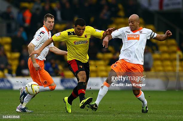 Troy Deeney of Watford battles with Kirk Broadfoot and Alex John-Baptiste of Blackpool during the npower Champions match between Watford and...