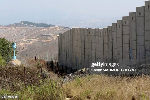 Picture taken from the southern Lebanese village of Houla shows the border fence between Lebanon and Israel, near the northern Israeli kibbutz of...