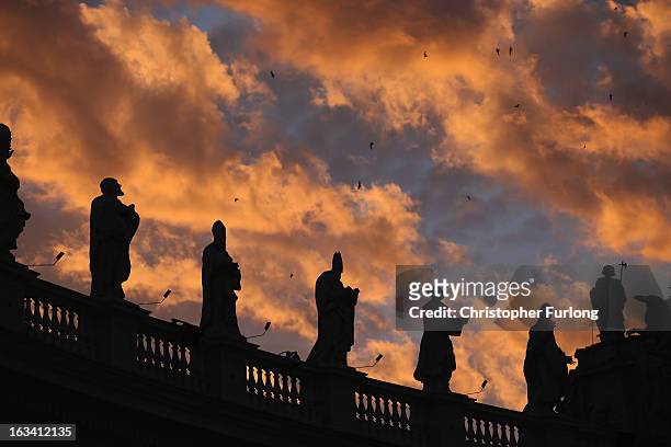 The sun sets over St. Peter's Square as cardinals prepare to vote for a new pope on March 9, 2013 in Vatican City, Vatican. Cardinals are set to...