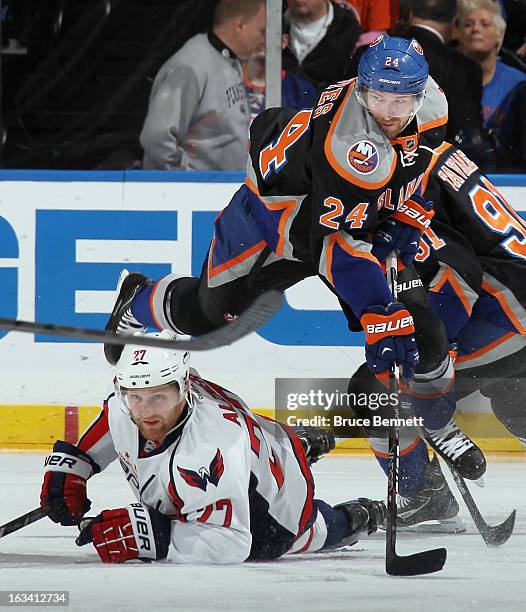 Brad Boyes of the New York Islanders jumps out of the way of a sliding Karl Alzner of the Washington Capitals during the first period at the Nassau...