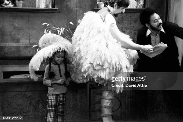 Matt Robinson and Carroll Spinney, in Big Bird costume, with a young girl on the set of Sesame Street's very first season, taken for America...