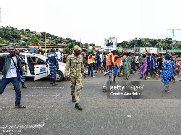 Supporters of the military administration gather on a street after Gabonese army officers enter the national television building following the...
