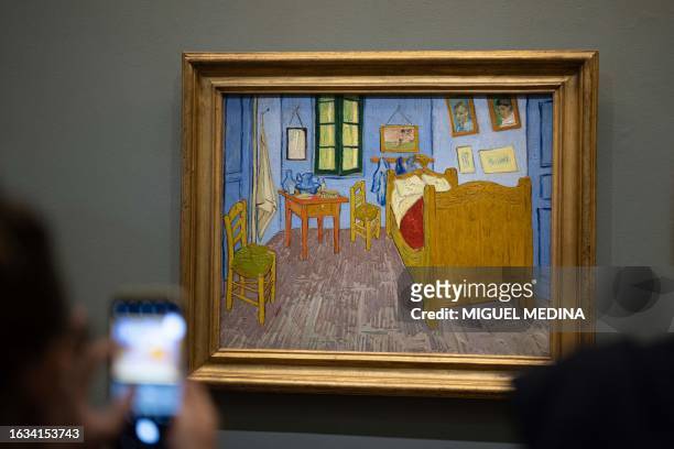 Visitors observe the painting "Van Gogh's bedroom in Arles " by Dutch post-impressionist painter Vincent van Gogh on display at The Orsay Museum in...