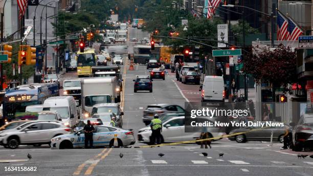 August 29: NYPD patrol cars block traffic from flowing on 57th Street between Sixth and Seventh Avenues early Tuesday August 29, 2023. Falling glass...