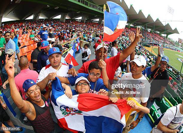 Fans of the Dominican Republic cheer their team on against Spain during the first round of the World Baseball Classic at Hiram Bithorn Stadium on...