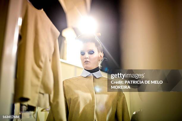 Model prepares backstage before Portuguese designer Alexandra Moura's Autumn/Winter 2013-2014 collection show during the 40th edition of the Moda...